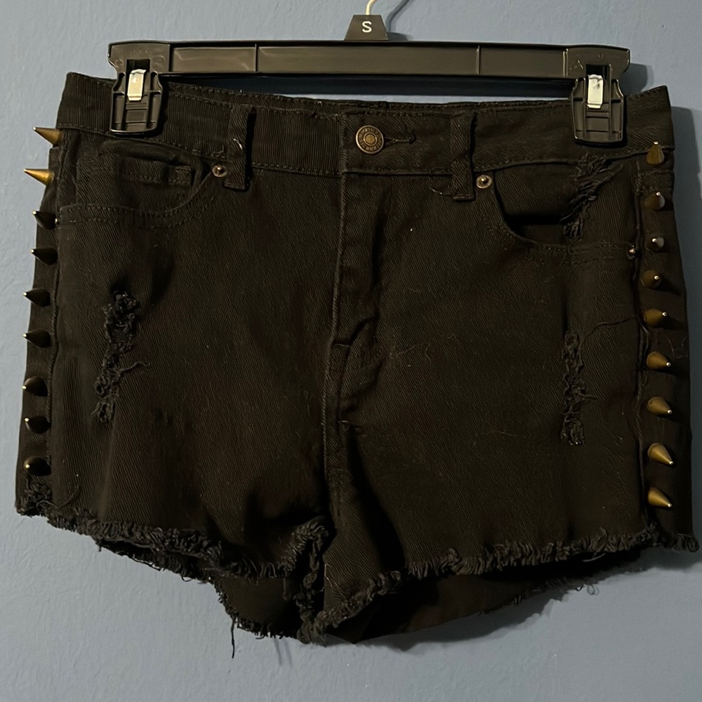 Black denim shorts with metal spikes